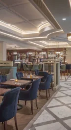 Elegant hotel dining area with cosy seating and ambient lighting, perfect for gatherings.