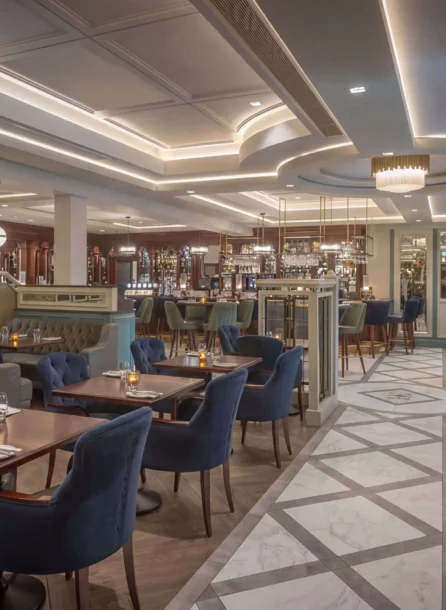 Elegant hotel dining area with cosy seating and ambient lighting, perfect for gatherings.