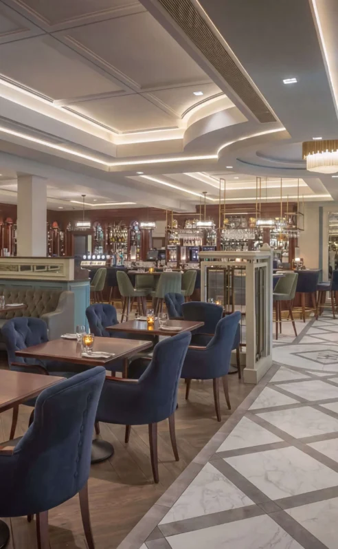 Elegant hotel dining area with cosy seating and ambient lighting, perfect for gatherings.