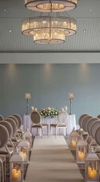 Elegant wedding ceremony setup at Hotel Kilmore with flower-adorned aisle and soft lighting.