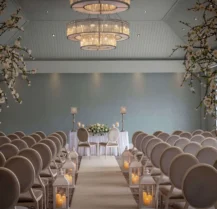 Elegant wedding ceremony setup at Hotel Kilmore with flower-adorned aisle and soft lighting.