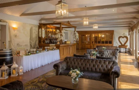 Family enjoying a cosy lounge at Hotel Kilmore with floral decor and warm lighting.