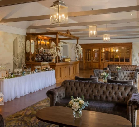 Family enjoying a cosy lounge at Hotel Kilmore with floral decor and warm lighting.