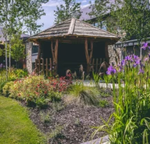 A charming gazebo surrounded by vibrant flowers in Hotel Kilmore's lush garden setting.