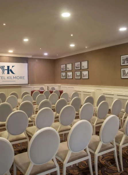 Elegant conference room at Hotel Kilmore with stylish seating and ambient lighting.