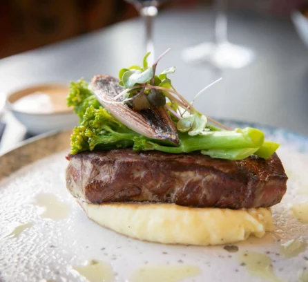 A delicious steak with broccoli, served with mash, on an elegant table setting at Hotel Kilmore.