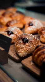 Freshly baked pastries on a wooden board at Hotel Kilmore's breakfast spread.