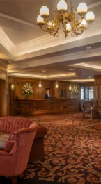A cosy hotel lobby with elegant seating and a welcoming fireplace.