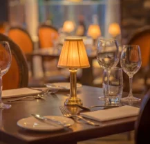 Elegant dining setting with soft lighting, wine glasses, cutlery, and a warm ambience at Hotel Kilmore.
