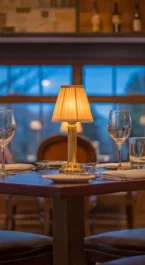 Cosy hotel restaurant with elegant table setting and dim lighting.