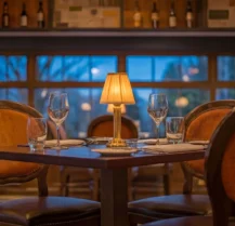 Cosy hotel restaurant with elegant table setting and dim lighting.
