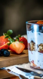 A delicious parfait with fresh berries at a hotel restaurant setting.