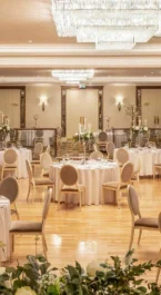 Elegant wedding reception setup at Hotel Kilmore with round tables and floral centrepieces.