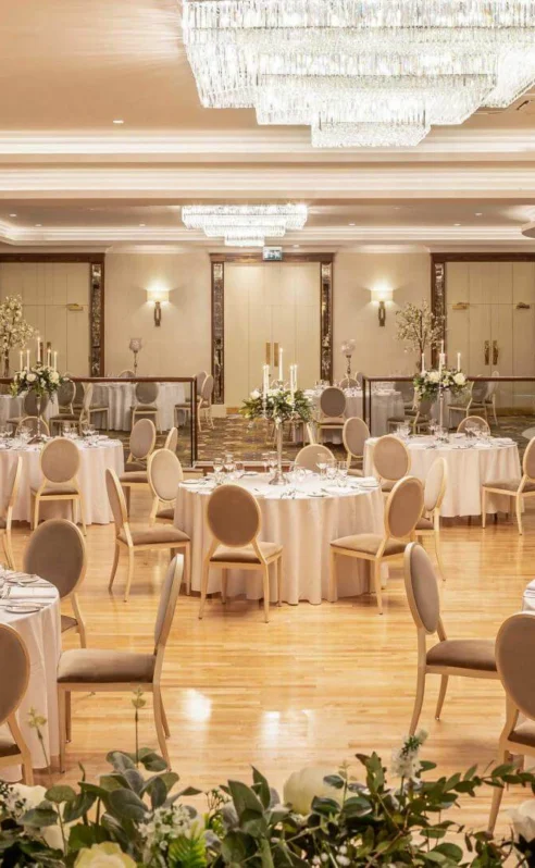 Elegant wedding reception setup at Hotel Kilmore with round tables and floral centrepieces.