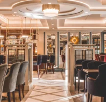 Elegant hotel dining area with cosy seating and ambient lighting.