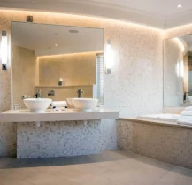 Luxurious hotel bathroom with modern fixtures and soft lighting.