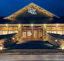 Hotel Kilmore entrance warmly lit with festive lights, inviting guests during the evening.