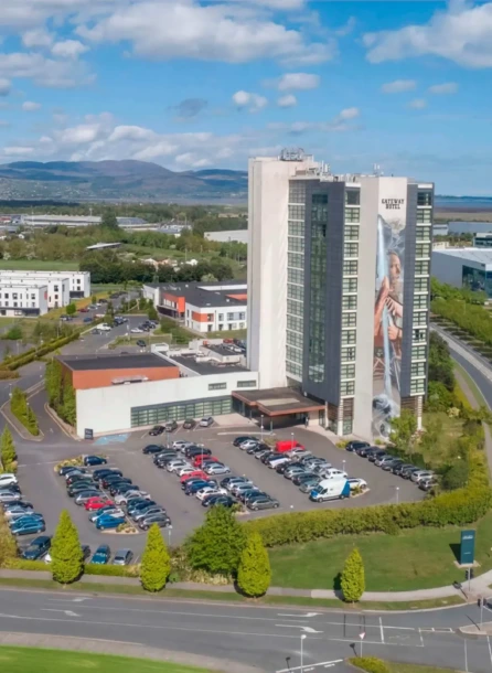 Aerial view of Hotel Kilmore surrounded by lush greenery and a clear blue sky.