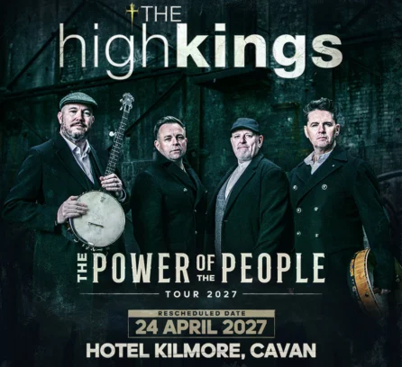 A music group stands together with instruments, promoting a 2027 tour at Hotel Kilmore.