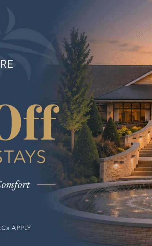 Elegant entrance of Hotel Kilmore with fountain and sunset.
